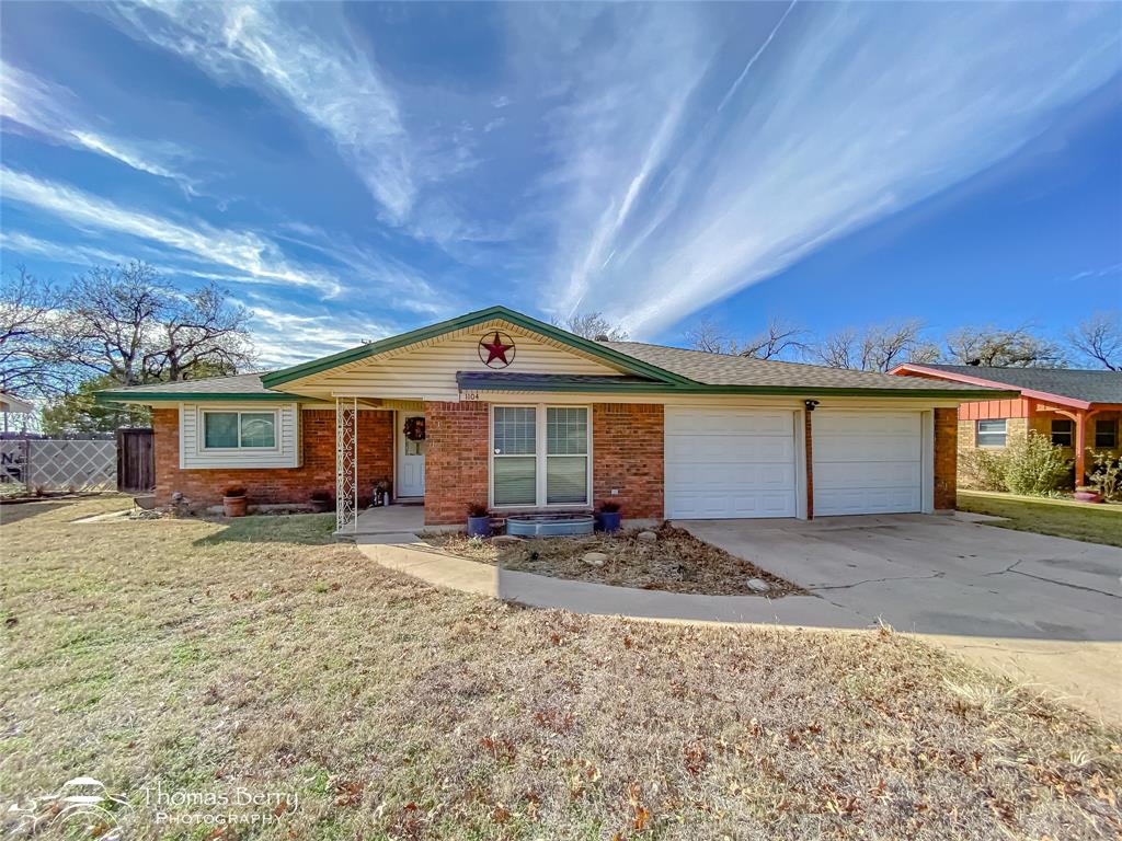 1104 Hickory Street Roscoe, TX 79545 - Photo 1 of 22 Ranch-style home with brick siding, driveway, an attached garage, and a shingled roof