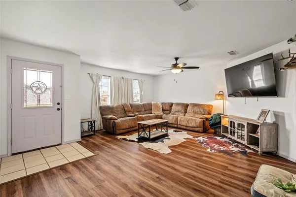 a living room with furniture and a flat screen tv