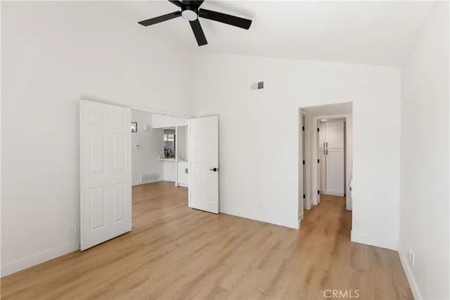 a view of a room with wooden floor and white walls