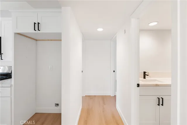 a view of a hallway with wooden floor