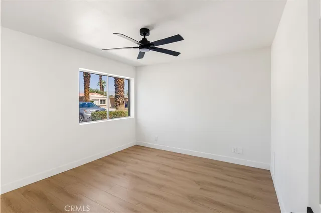 a view of a big room with wooden floor closet and windows