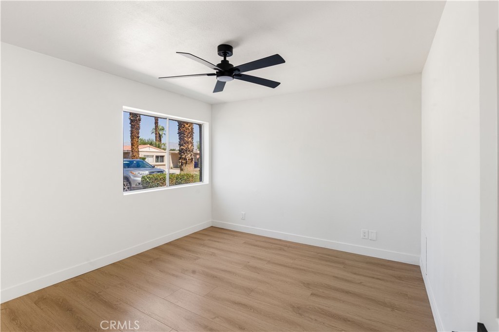 82151 Waring Way Indio, CA 92201 - Photo 17 of 22 a view of a big room with wooden floor closet and windows