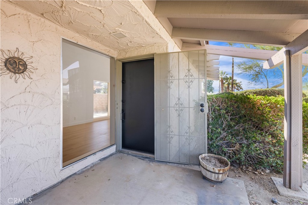 82151 Waring Way Indio, CA 92201 - Photo 2 of 22 a view of a room that has a glass door and a large window