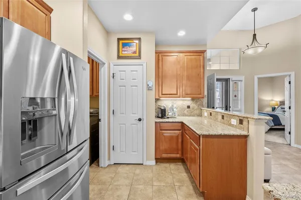 a kitchen with stainless steel appliances granite countertop a refrigerator and a sink