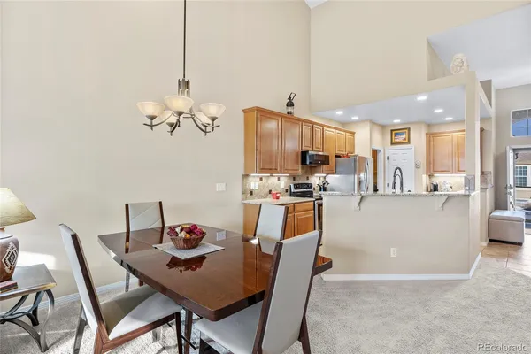 a living room with kitchen island furniture and a chandelier