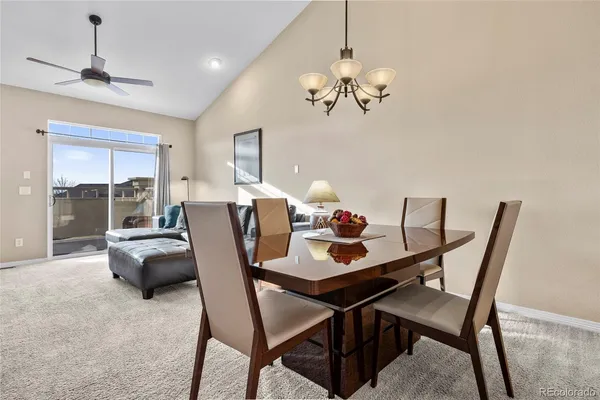 a view of a dining room with furniture wooden floor and chandelier