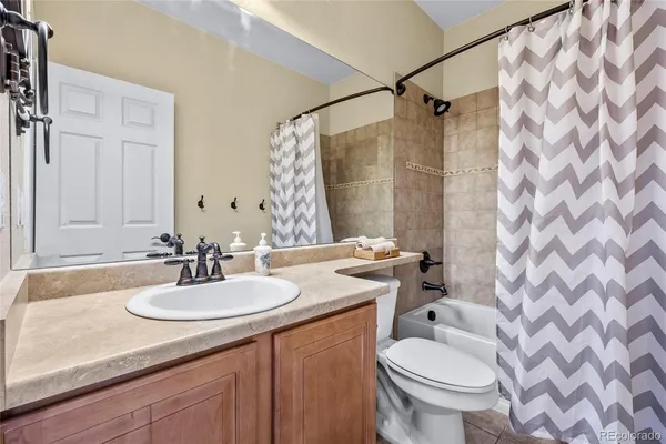 a living room with fireplace furniture and a flat screen tv