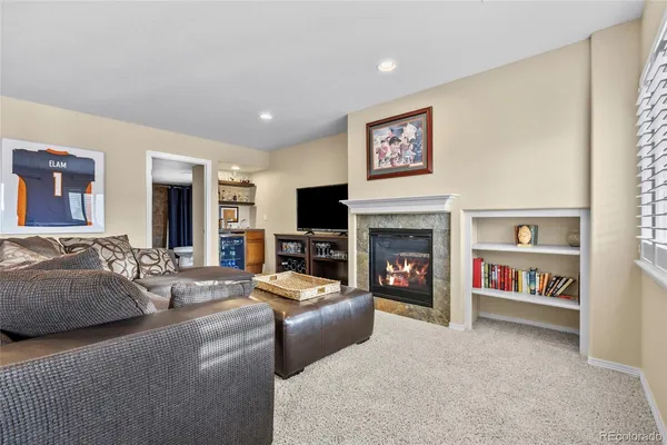 a living room with furniture a flat screen tv and a fireplace
