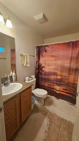 a spacious bathroom with a granite countertop sink and a mirror
