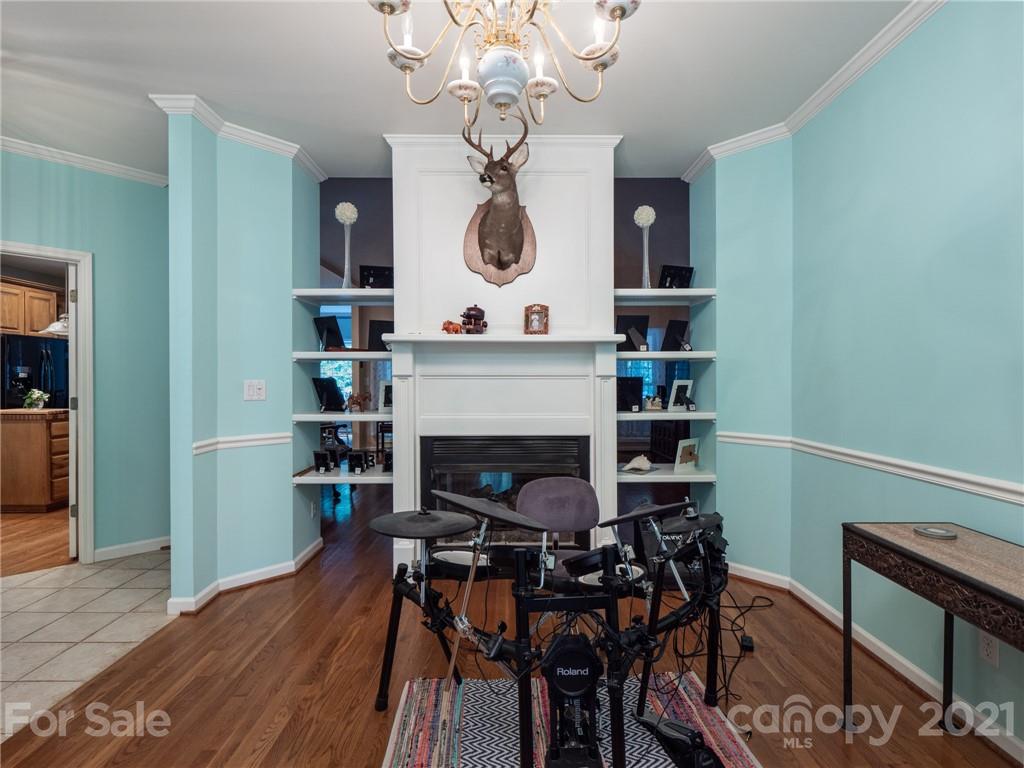 9141 Sunrise Meadow Road Fort Mill, SC 29715 - Photo 12 of 45 a view of a dining room with furniture wooden floor and a chandelier
