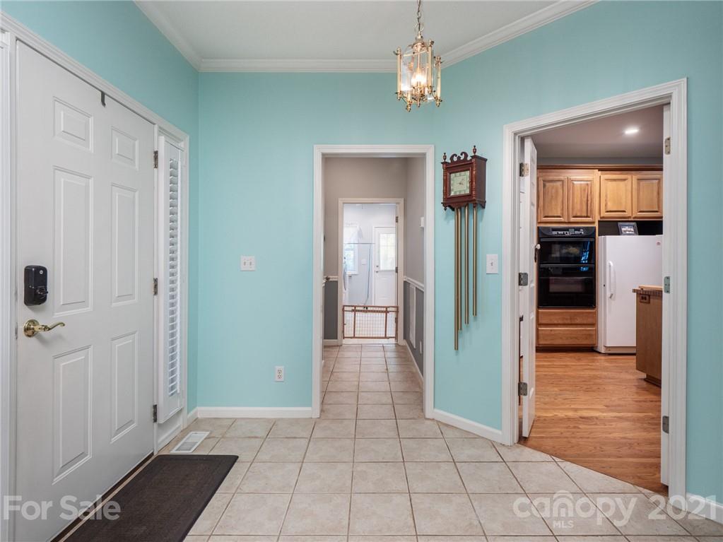 9141 Sunrise Meadow Road Fort Mill, SC 29715 - Photo 13 of 45 a view of a hallway with wooden floor and a bathroom