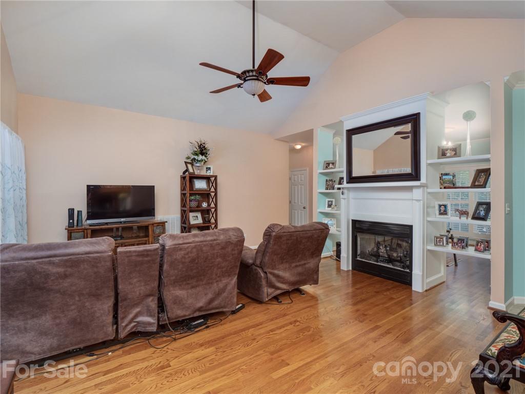 9141 Sunrise Meadow Road Fort Mill, SC 29715 - Photo 15 of 45 a living room with furniture a flat screen tv and a fireplace