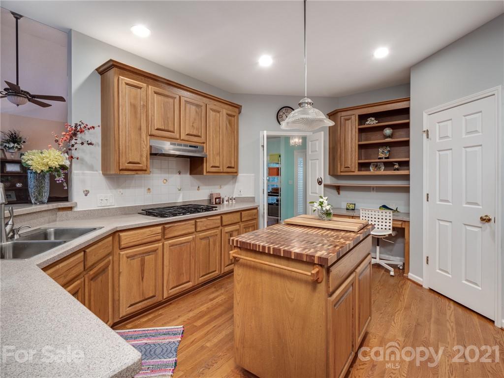 9141 Sunrise Meadow Road Fort Mill, SC 29715 - Photo 19 of 45 a kitchen with stainless steel appliances granite countertop a stove sink and cabinets