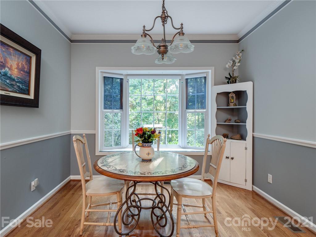 9141 Sunrise Meadow Road Fort Mill, SC 29715 - Photo 20 of 45 a dining room with furniture a window and chandelier