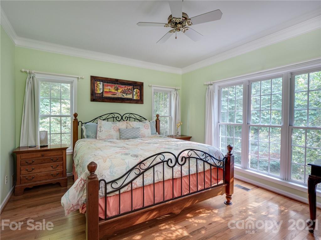 9141 Sunrise Meadow Road Fort Mill, SC 29715 - Photo 22 of 45 a bedroom with a bed a dresser with wooden floor