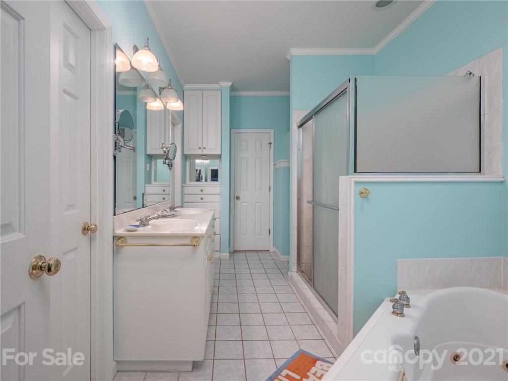 9141 Sunrise Meadow Road Fort Mill, SC 29715 - Photo 24 of 45 a bathroom with a tub sink and mirror