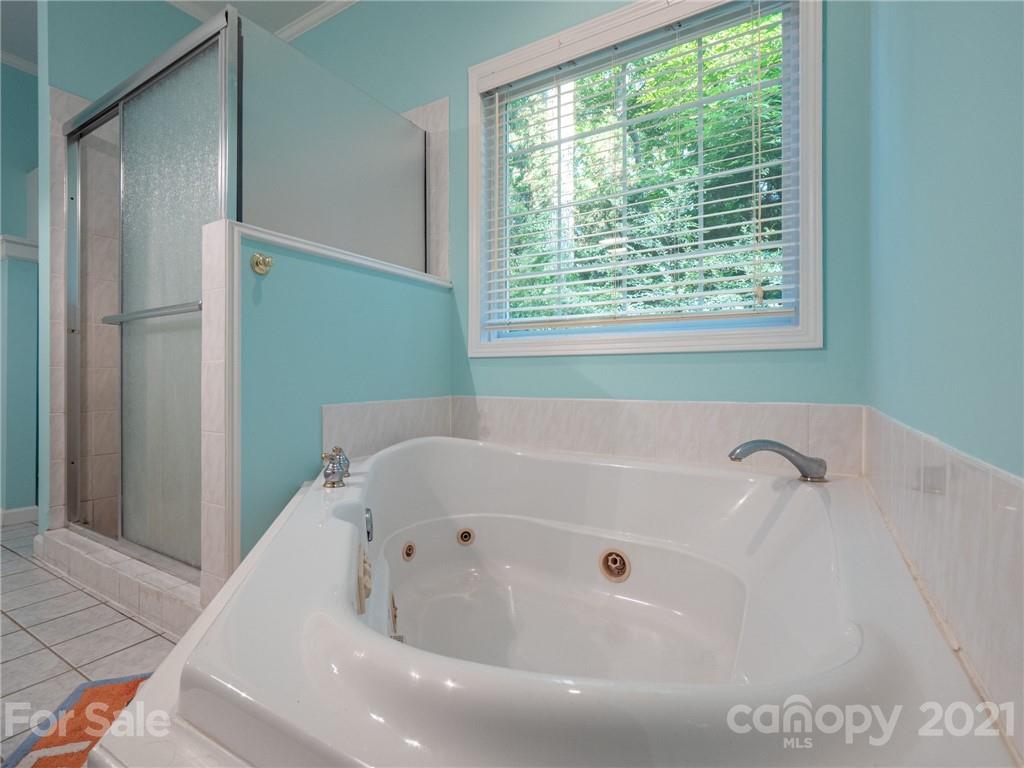 9141 Sunrise Meadow Road Fort Mill, SC 29715 - Photo 26 of 45 a white bath tub sitting in a bathroom next to a window