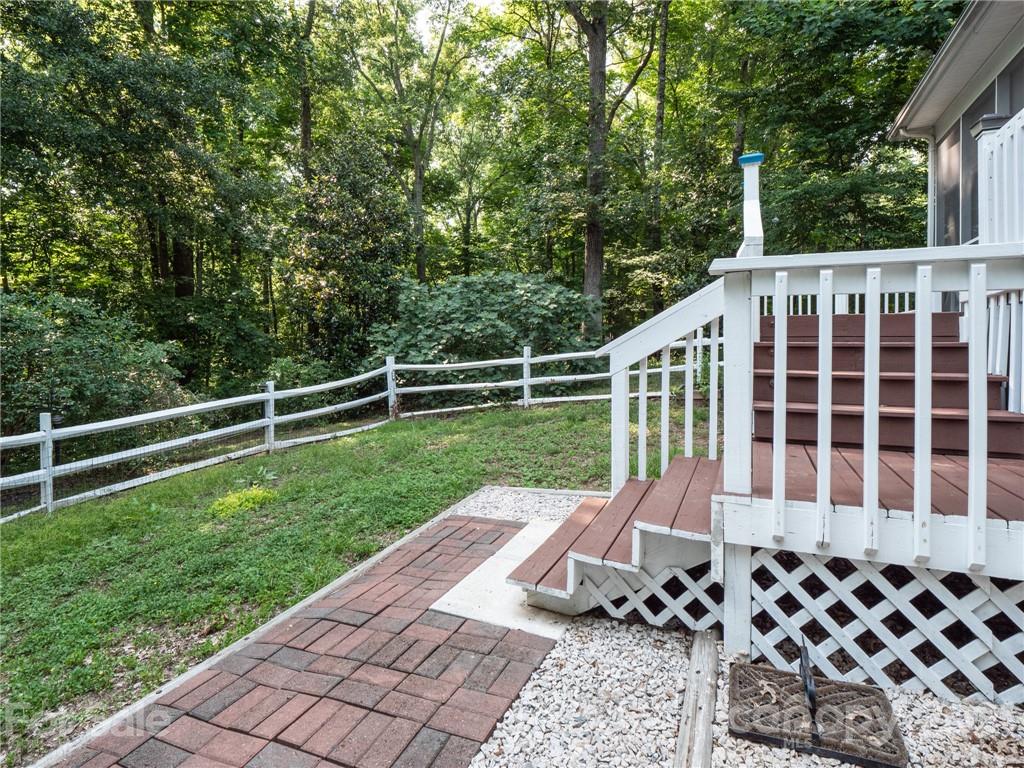 9141 Sunrise Meadow Road Fort Mill, SC 29715 - Photo 32 of 45 a view of a deck with two chair and wooden floor