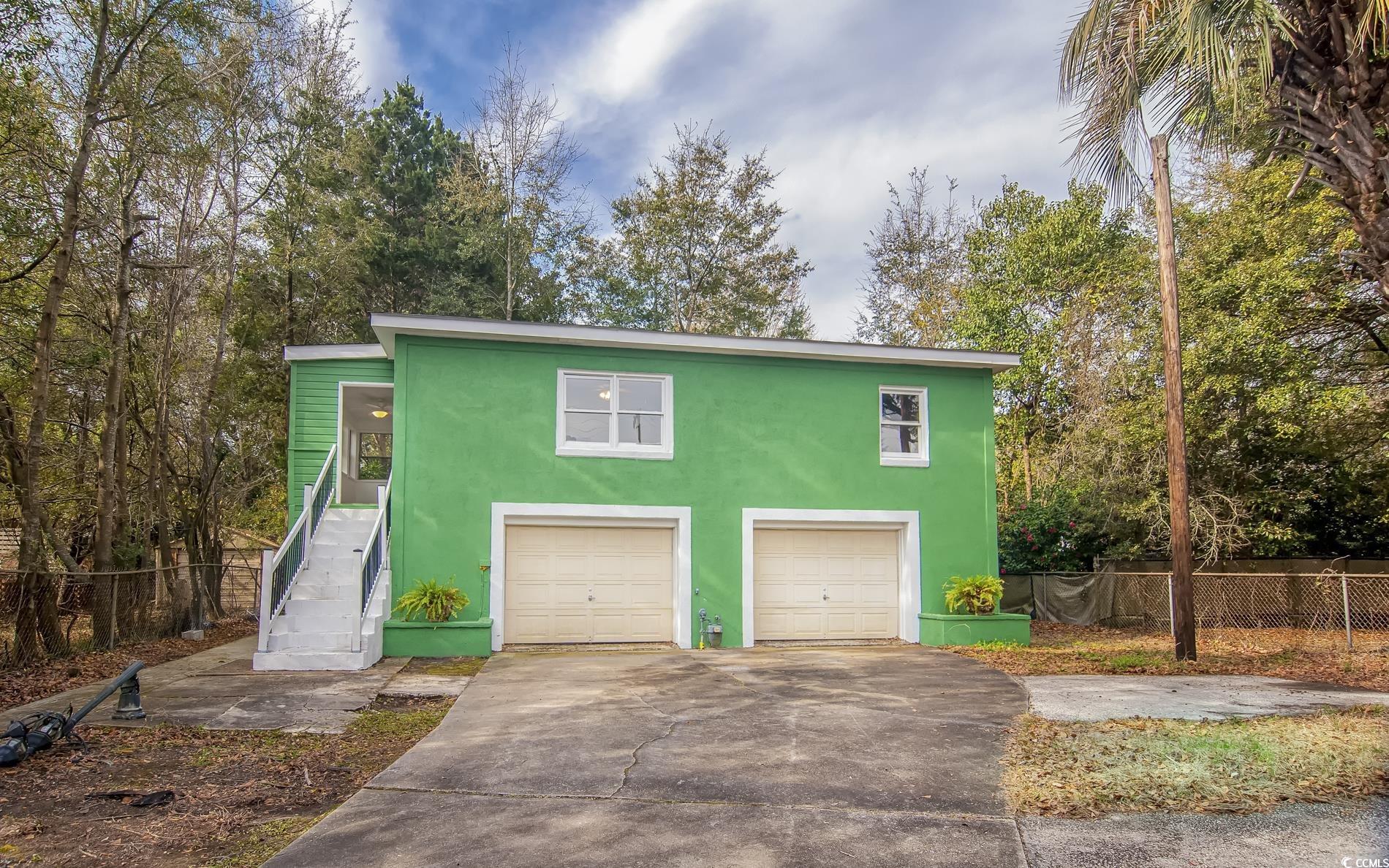 1019 Prince Street Georgetown, SC 29440 - Photo 14 of 22 Garage with concrete driveway and fence