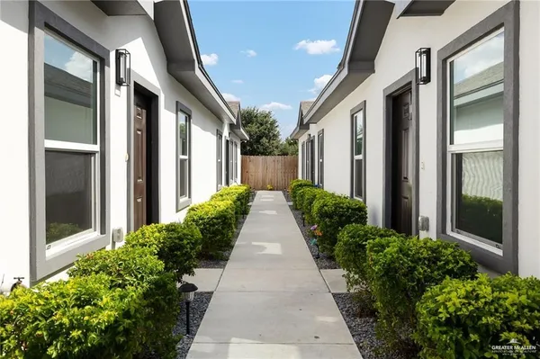 a view of a pathway both side of house