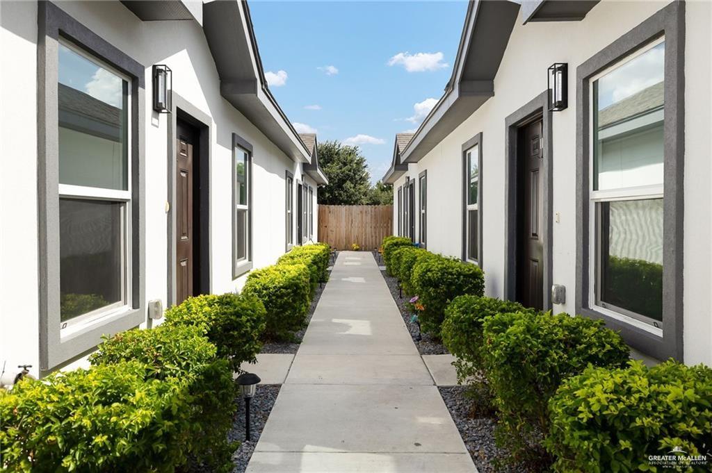 a view of a pathway both side of house