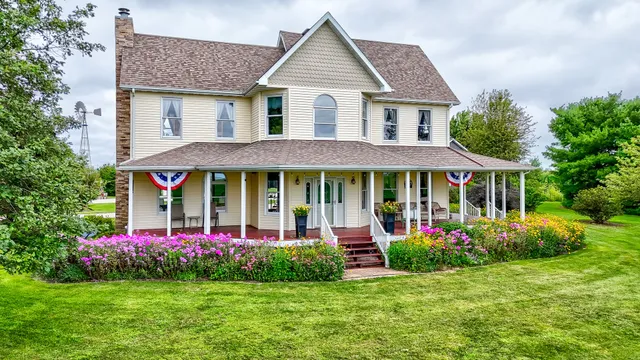 an aerial view of a house with outdoor space tennis court