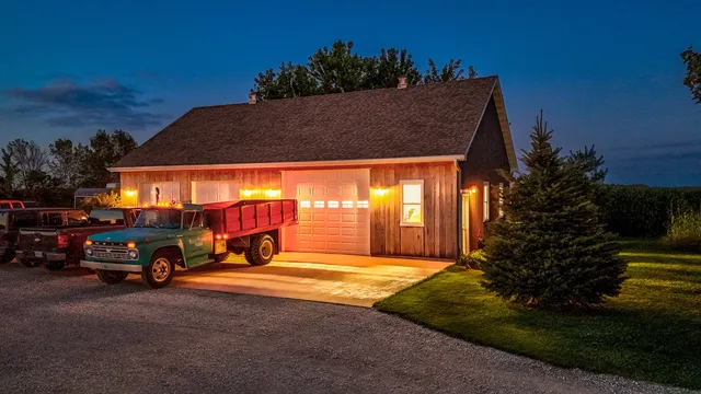 a view of backyard with potted plants and wooden fence