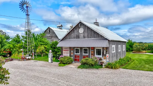 a view of a house with a yard and potted plants