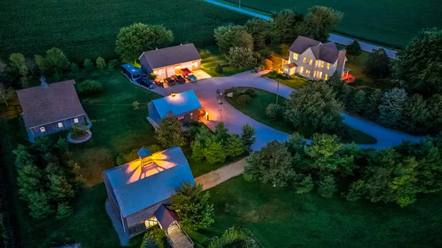 a view of a livingroom with wooden floor and furniture