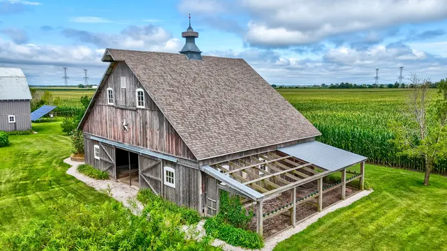 an aerial view of residential house with an outdoor space and seating