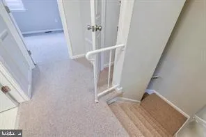 a view of staircase with white walls and window