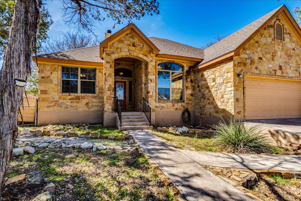 11 Rhapsody Lane Wimberley, TX 78676 - Photo 3 of 35 a front view of a house with a yard