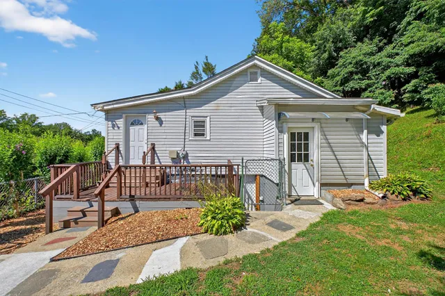 a view of a house with a yard and sitting area