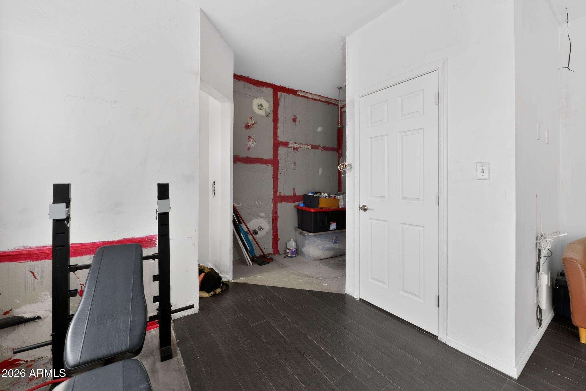 277 Círculo Silva Rio Rico, AZ 85648 - Photo 26 of 34 a view of a bedroom with wooden floor and gym equipment