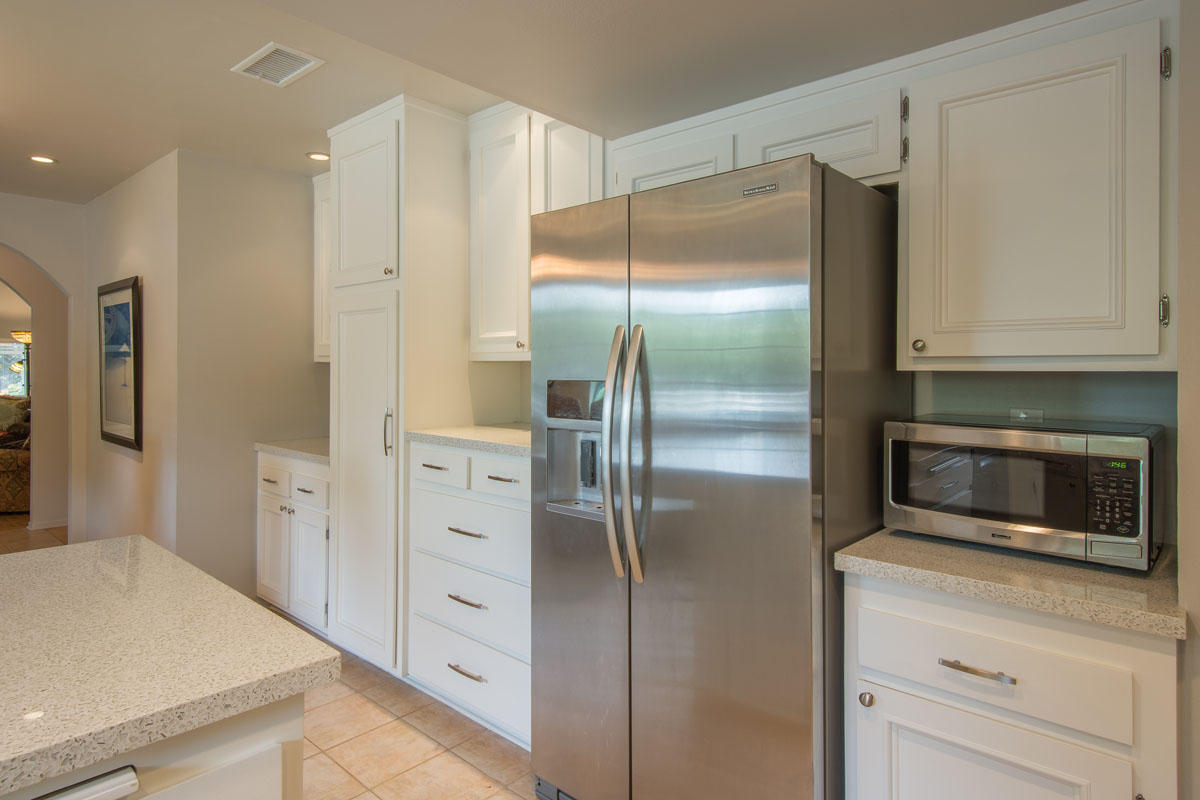 511 Fellowship Road Santa Barbara, CA 93109 - Photo 9 of 24 a kitchen with white cabinets and refrigerator