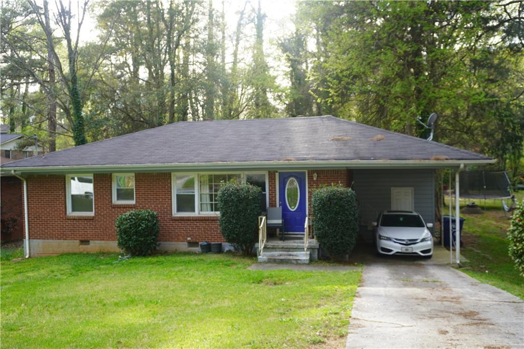 2431 Springdale Road Southwest Atlanta, GA 30315 - Photo 1 of 1 a front view of a house with a garden and trees