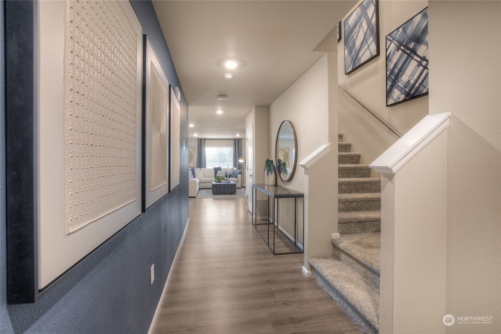909 17th Avenue, Unit 159 Sultan, WA 98294 - Photo 2 of 15 a view of a hallway with wooden floor and staircase