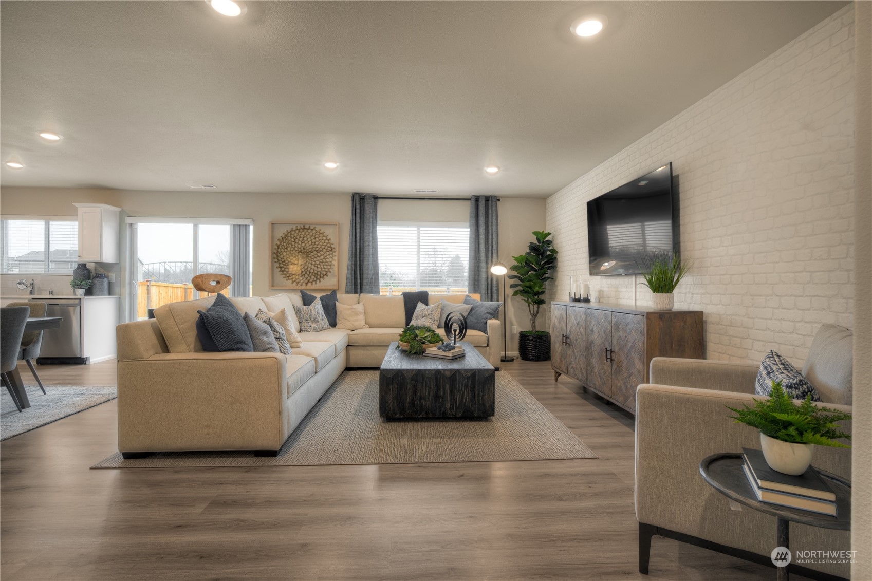 909 17th Avenue, Unit 159 Sultan, WA 98294 - Photo 3 of 15 a living room with furniture and a flat screen tv
