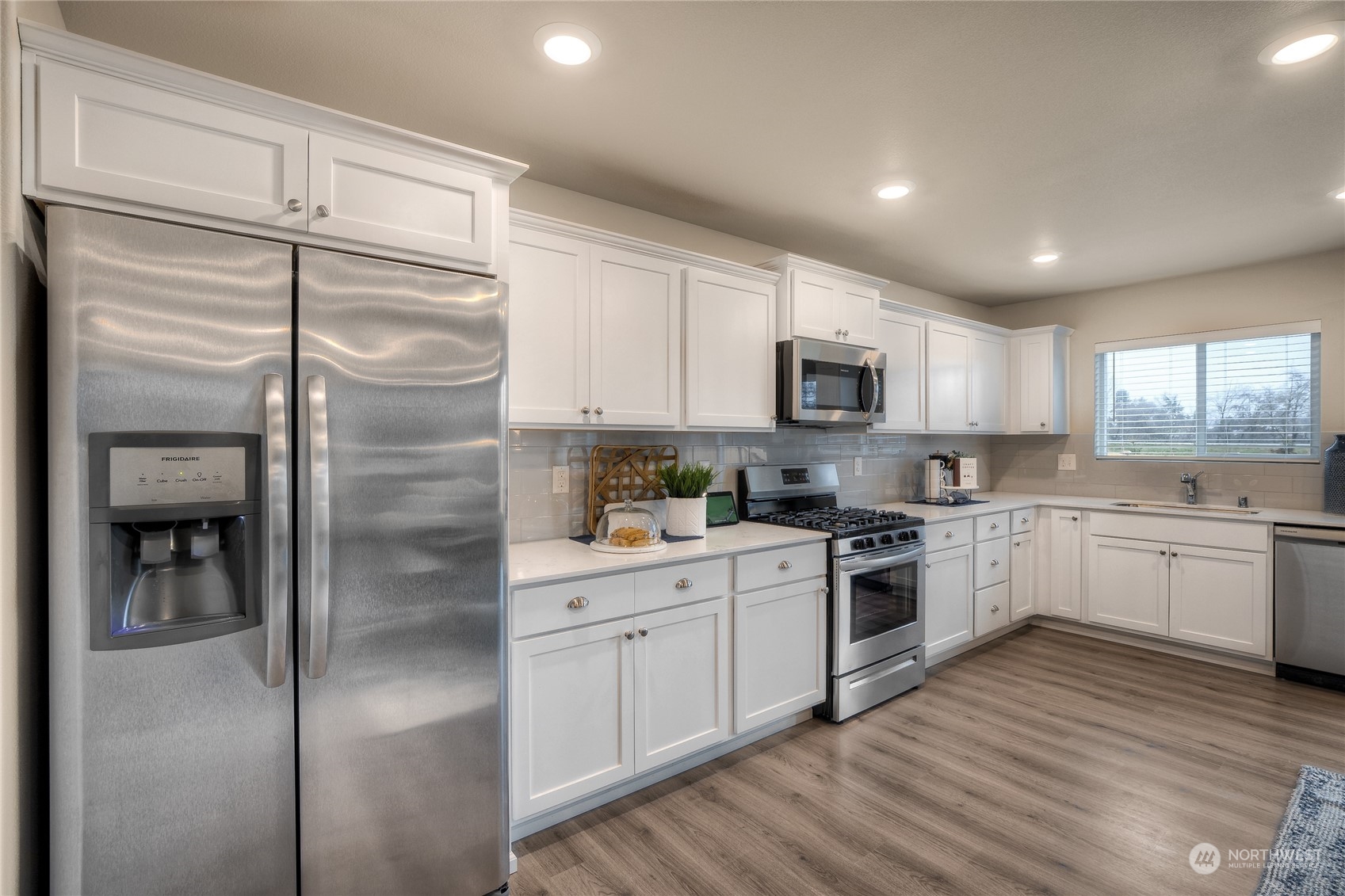 909 17th Avenue, Unit 159 Sultan, WA 98294 - Photo 5 of 15 a kitchen with a refrigerator stove top oven and sink