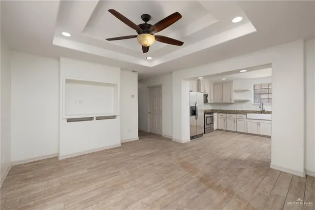 a view of a kitchen with a sink and a refrigerator