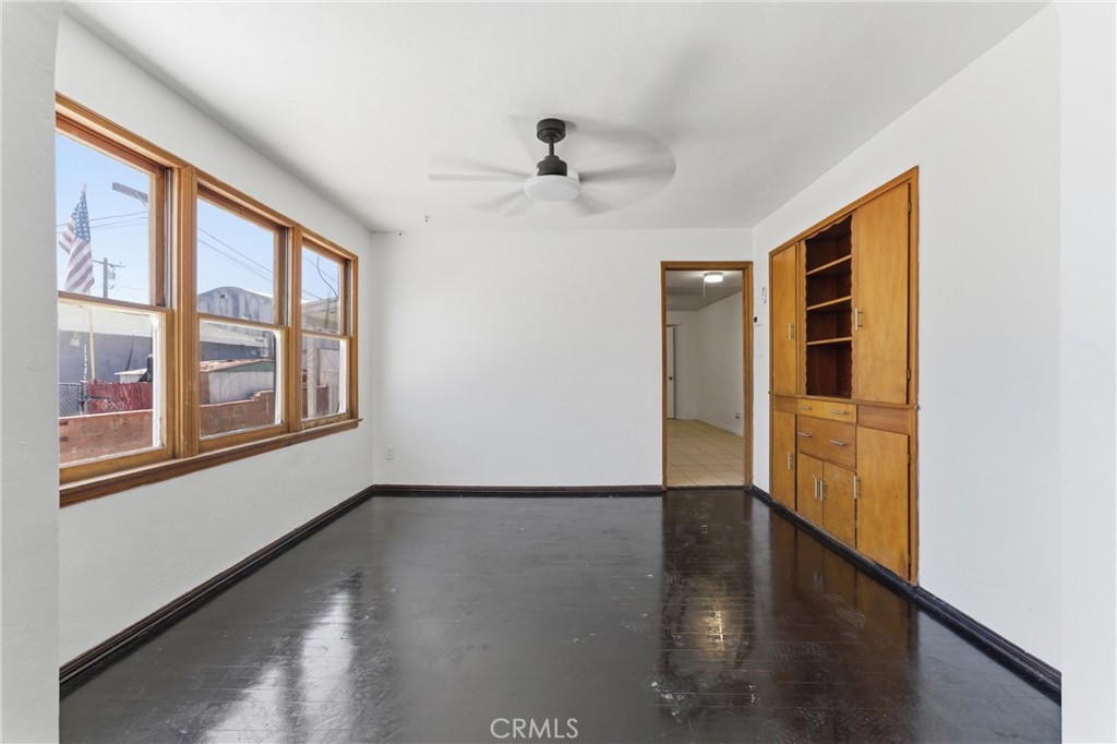 44509 Date Lancaster, CA 93534 - Photo 5 of 20 a view of an empty room with wooden floor and a window