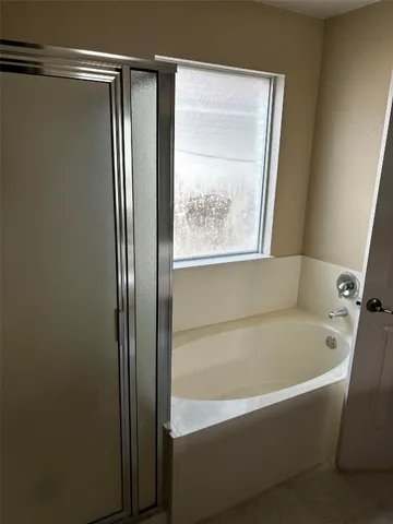 a bathroom with a bathtub and a shower