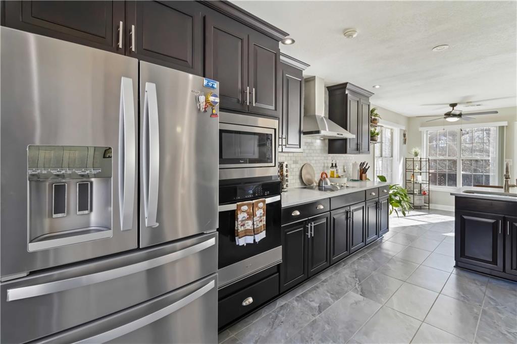 180 Harper Road McDonough, GA 30252 - Photo 16 of 63 a kitchen with stainless steel appliances a refrigerator sink and stove