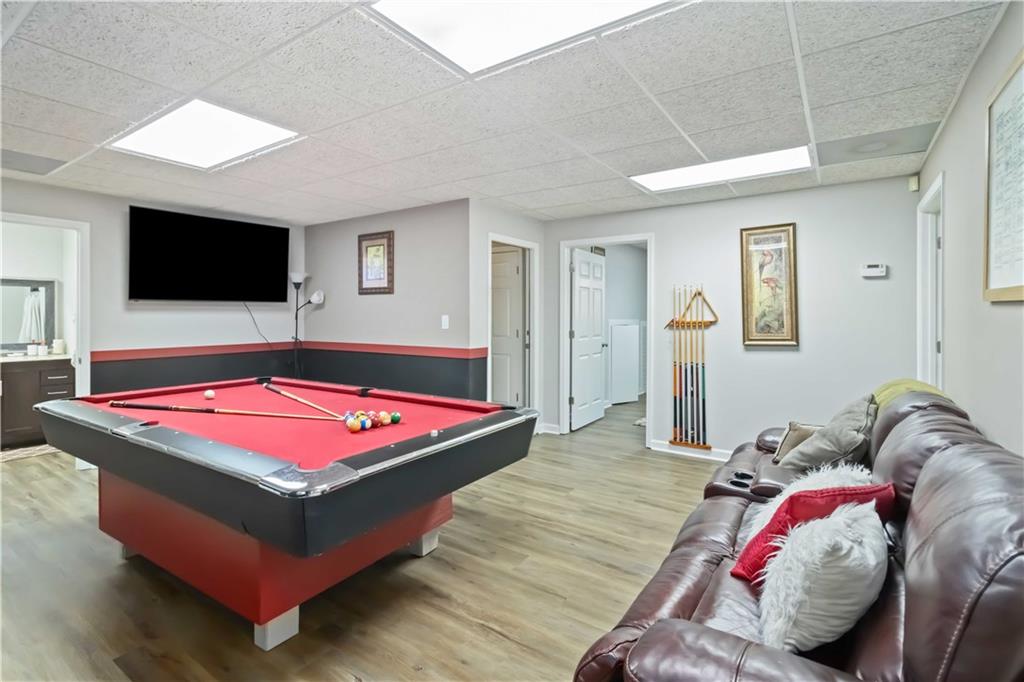 180 Harper Road McDonough, GA 30252 - Photo 17 of 63 a spacious bedroom with a bed and a flat screen tv