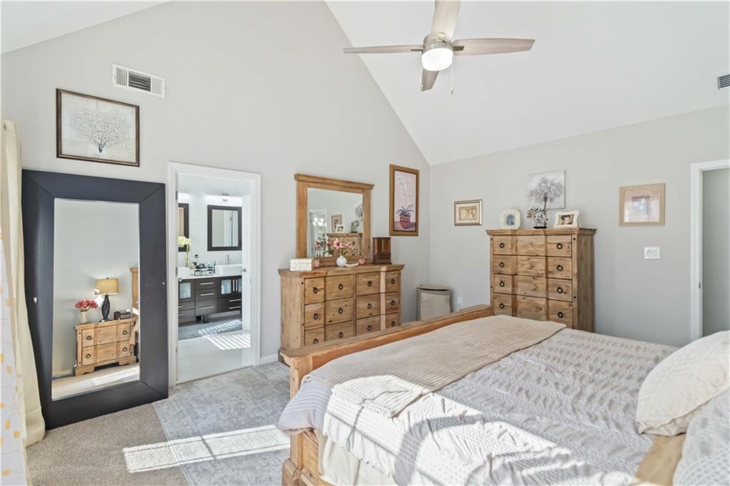 180 Harper Road McDonough, GA 30252 - Photo 2 of 63 a bedroom with a large bed a chandelier and closet