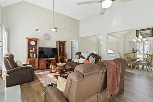 a view of sitting area on roof with wooden floor and fence