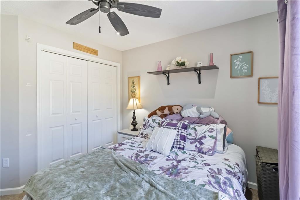 180 Harper Road McDonough, GA 30252 - Photo 25 of 63 a bedroom with a bed and a chandelier