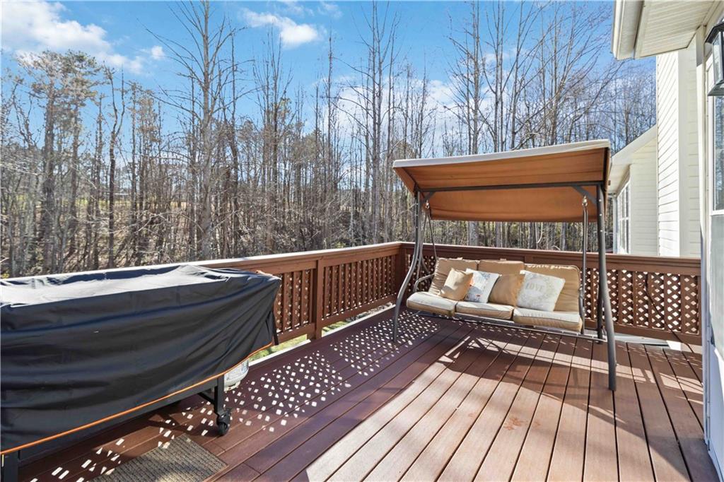 180 Harper Road McDonough, GA 30252 - Photo 27 of 63 a view of sitting area on roof with wooden floor and fence
