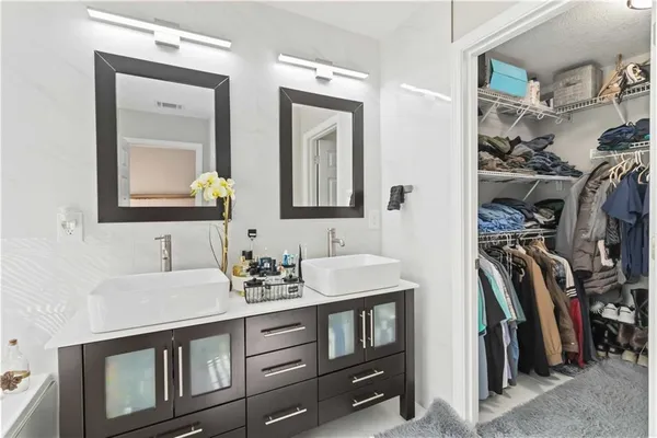 a living room with furniture a fireplace and a chandelier