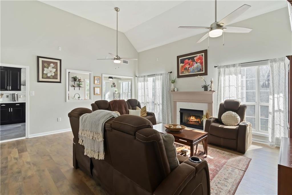 180 Harper Road McDonough, GA 30252 - Photo 38 of 63 a living room with furniture a fireplace and a flat screen tv